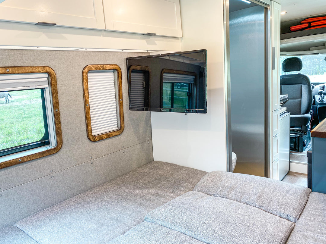 van conversion with a convertible bed couch and satellite tv