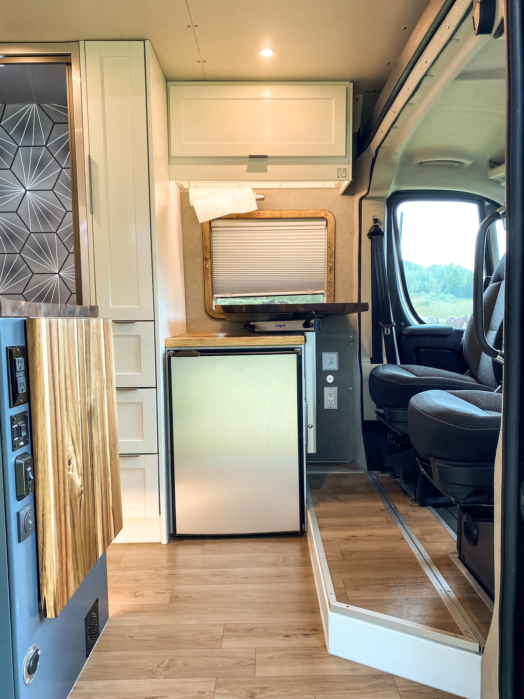 Van conversion closet with mini fridge, lagun table and swivel seats