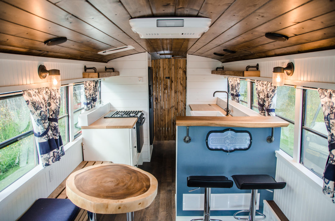 Modern farmhouse school bus conversion with tongue and groove walnut stained roofing